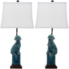 a pair of blue foo foo lamps with white shades