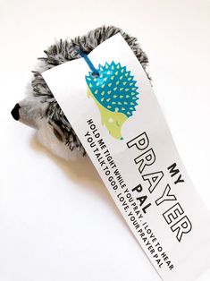 a toy hedgehog holding a sign that says for rayy ega on it