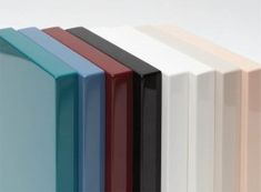 a row of different colored books sitting on top of each other