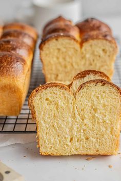 several loaves of bread sitting on a cooling rack