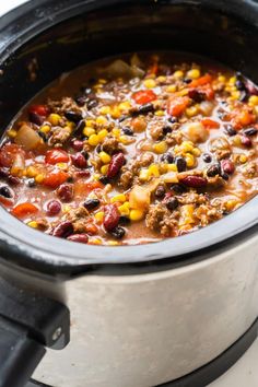 a crock pot filled with chili and corn