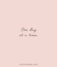 the words one day at a time are written in black ink on a pink background