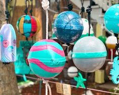 several different colored balls hanging from ropes