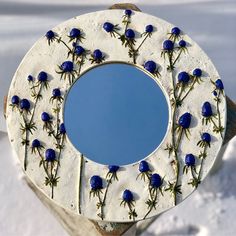 there is a mirror with blue flowers on it