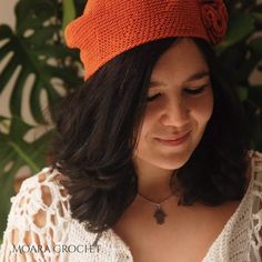 a woman wearing an orange crochet hat