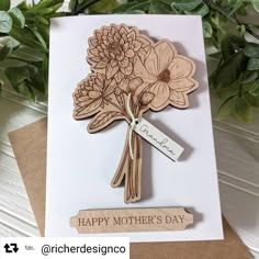 a mother's day card with flowers on it and a tag hanging from the front