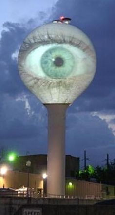 an eyeball is shown on top of a tall tower