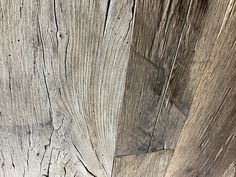 an old wooden wall with peeling paint and chipped wood grains on the surface