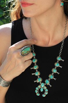 This authentic Royston Turquoise Squash Blossom Necklace is a perfect size. It’s much smaller and lighter than a full-size Squash Blossom necklace and has plenty of sterling silver chain to adjust the length. It is so wearable! Twenty free form pieces of beautiful blue Royston turquoise are bezel set. The bottom horseshoe-shaped piece is called a naja. It is a good luck symbol borrowed from the Moors’ culture of Spain. Matching earrings are included. Handmade by a Navajo silversmith in New Mexic Mother Of Pearl Squash Blossom Necklace, Turquoise Jewelry Native American Squash Blossom, Turquoise Squash Blossom Necklace, Navajo Squash Blossom Necklace, Turquoise Squash Blossom, Squash Blossom, Turquoise Jewelry Native American, Squash Blossom Necklace, Native American Artifacts