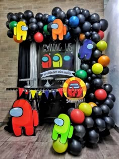 an arch made out of balloons in front of a sign that says eymong us