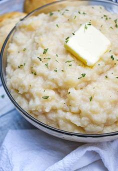 a bowl filled with rice and butter on top of a table