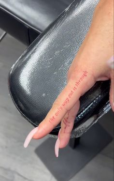 a person's hand with the word love written on it, sitting in front of a chair