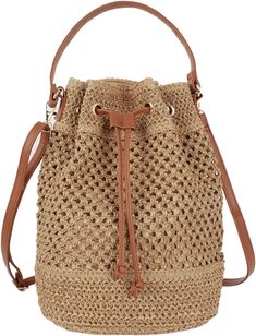 a straw bucket bag with leather handles and drawstrings on the bottom,