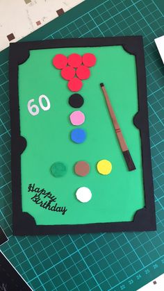 a pool table cake with the number 60 on it's side and some paint