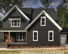 a gray house with white trim and windows