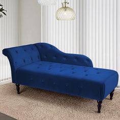 a blue couch sitting on top of a carpeted floor