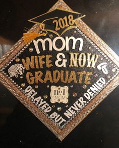 a graduation cap that says mom, wife and now graduate