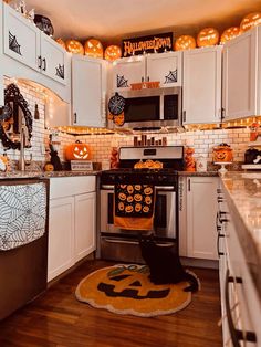 a kitchen decorated for halloween with pumpkins and decorations