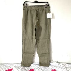 Ellen Tracy Linen Drawstring Casual Pants. Light Olive Green Color. Lightweight, Flowy 100% Linen Material. Elastic Waistband, Drawstring With Gold Tone Grommet Detail. Pocketless Style For Flattering Silhouette. Slight Tapered Leg . Lightweight Material. . Waist 14 1/2” Flat Aprox . Rise 10 1/2” Aprox . Length 28 1/2” Aprox Khaki Summer Loungewear Pants, Khaki Bottoms With Drawstring For Spring, Spring Khaki Bottoms With Drawstring, Khaki Drawstring Bottoms For Spring, Spring Khaki Drawstring Bottoms, Spring Ankle-length Pants With Drawstring, Drawstring Pants For Spring Loungewear, Spring Drawstring Loungewear Pants, Spring Drawstring Lounge Pants