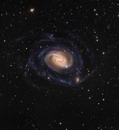 a spiral galaxy with stars in the background