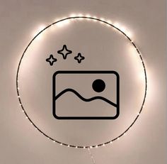 a circle with some lights around it that has a bed and stars on the wall