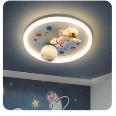 an astronaut themed ceiling light in a child's room