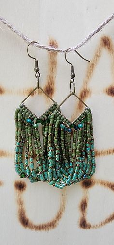 Elevate your style with our handcrafted Beaded Fringe Earrings. These stunning earrings feature intricate beadwork, cascading delicately to create a dynamic fringe effect. Perfect for adding a touch of elegance and movement to any outfit, these earrings are lightweight yet striking, making them ideal for both day and evening wear. The vibrant colors and unique design make them a standout accessory, whether you're dressing up for a special occasion or adding flair to your everyday look. Embrace the artistry and sophistication of beaded jewelry with these must-have statement earrings. Adjustable Green Chandelier Earrings With Dangling Beads, Adjustable Green Fringe Beaded Earrings, Adjustable Green Beaded Chandelier Earrings, Green Beaded Bohemian Chandelier Earrings, Bohemian Green Beaded Chandelier Earrings, Adjustable Bohemian Chandelier Earrings With Beaded Fringe, Bohemian Green Beaded Fringe Chandelier Earrings, Ombre Fringe Earrings, Stitch Earrings