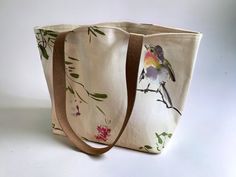 Bird themed canvas tote, fully lined with a magnetic clasp. Tote size is a medium sized tote 16inches x 11inches x 6 inches. Handles are 1 inch leather with 10.5 inch drop. Tote is interfaced so sides stand as shown in the photo. You will receive the item pictured in the photo. Canvas Bag With Removable Pouch As Gift, Large Canvas Shoulder Bag Gift, Canvas Shoulder Bag With Rolled Handles, Cream Canvas Bag As A Gift, Cream Canvas Bags As Gift, Cream Canvas Bags For Gifts, Cream Canvas Bag Perfect For Gifts, Rectangular Cotton Canvas Bag With Rolled Handles, Rectangular Cotton Shoulder Bag With Rolled Handles