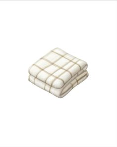 two white and brown plaid blankets on top of each other in front of a white background