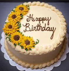 a birthday cake decorated with sunflowers and the words happy birthday written on it