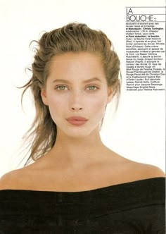 a woman with long hair is posing for a magazine cover shot in black off the shoulder dress