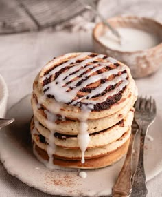 a stack of pancakes covered in icing on top of a plate