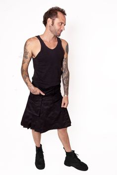 "Mens pleated skirt Kilt inspired Black cotton twill 7 topstitched pleats on each side Fly and button closure 5 belt loops Large removable pocket : Buttons for side fixing Large belt loop on the pocket S : waist 84 cm / 33\", lenght 53 cm / 20¾\" M : waist 91 cm / 35¾\", lenght 55 cm / 21¼ \" L : waist 98 cm / 38½\", lenght 57 cm / 22 ½\" XL : waist 104 cm / 41\", lenght 59 cm / 23¼\" 2XL : waist 112 cm / 44\", lenght 61 cm / 24\"" Fitted Punk Skirt With Pockets, Punk Style Cotton Pleated Skirt, Cotton Skirt With Belt Loops, Punk Mini Skirt With Pockets, Spring Cotton Cargo Skirt With Belt Loops, Fitted Cotton Cargo Skirt With Pockets, Fitted Black Cargo Skirt With Belt Loops, Spring Punk Cotton Skirt, Cotton Accordion Pleated Skirt