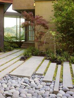 an outdoor garden with rocks and grass