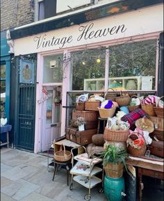 an old fashioned store front with baskets on display