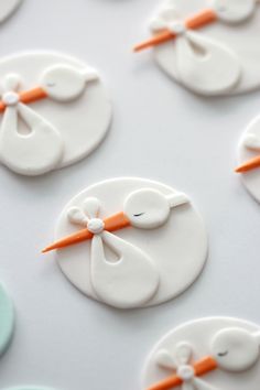 some white and orange decorated cookies on a table