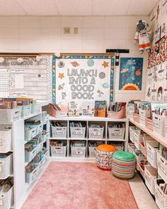 a room filled with lots of books and baskets on the floor in front of a whiteboard