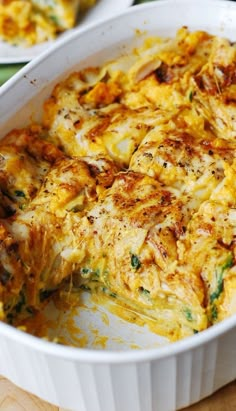 a casserole dish with broccoli and cheese in it on a wooden table