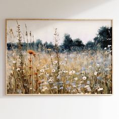 a painting hanging on the wall next to a chair in a room with white walls