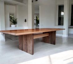 a large wooden table sitting in the middle of a room