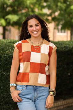 Our "Erin Colorblock Top (Brown Multi)" is a rust colored vest with different shades of orange and brown. It is a super soft material and perfect for back to school! Our model is wearing a size Small. Brown Sleeveless Tank Top For Fall, Trendy Brown Vest For Fall, Casual Multicolor Tank Top For Fall, Brown Vest Top For Layering, Brown Sweater Vest For Layering, Trendy Brown Sweater Vest For Layering, Casual Brown Vest For Fall, Trendy Multicolor Fall Vest, Brown Patchwork Vest For Fall