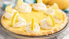 a pie with lemons and whipped cream on top