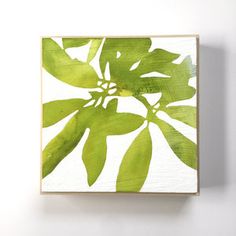 a green leafy painting on a white wall