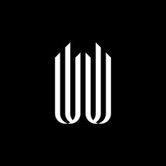 a black and white logo with the letter w in it's center, on a dark background