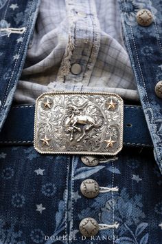 WHOA COWBOY! The stunning silverwork present in this piece is truly something to behold. This bold statement buckle boasts intricate scroll engraving and a detailed dimensional bucking bronc in the midst of a sterling silver shield. Four 10k gold fill stars were placed in the corners giving it the exact details it needed. A buckle like this one can be added to any belt to complete any outfit. hallmarks: Double D Ranch materials: sterling silver, 10K gold fill measurements: 3 1/2" x 2 1/2" weight Scroll Engraving, Collar Tips, Double D Ranch, Cowboy Belt, Cashmere Accessories, Stocking Gifts, Vintage Horse, Jewelry Pins