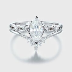 a white gold ring with a pear shaped diamond