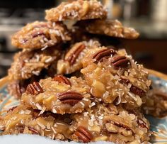 several pieces of pecan cookies stacked on top of each other with coconut flakes