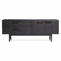 the sideboard with three drawers is made from dark wood and has two brown leather handles