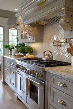 a kitchen with an oven, stove and counter tops in the middle of the room