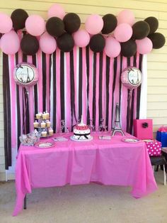 a pink and black dessert table with balloons on the wall behind it for an elegant birthday party